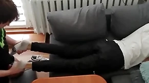 Young suppliant pays out his bills all over his feet